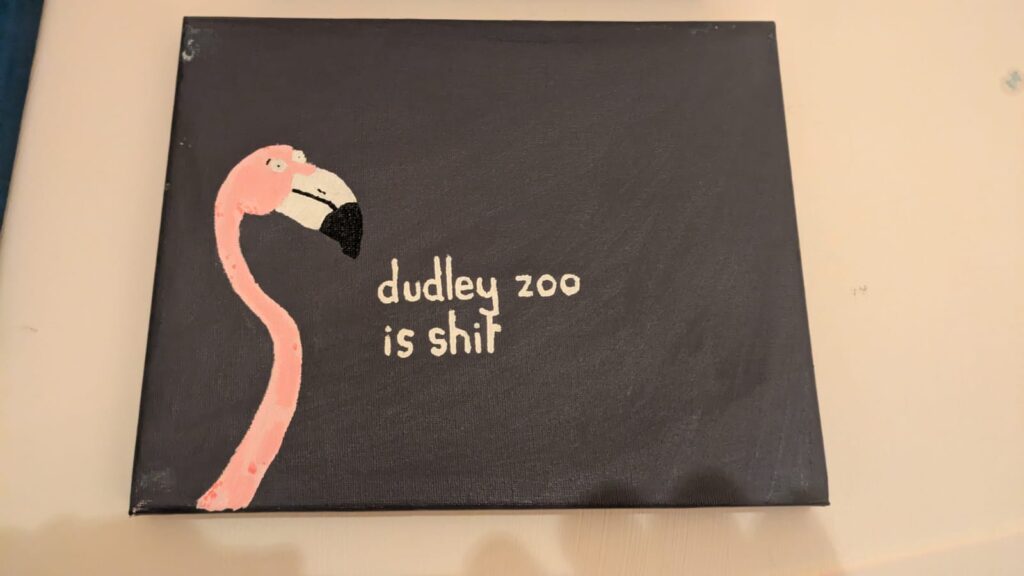 A painting with a dark brown background, a flamingo and the text 'dudley zoo is shit'.